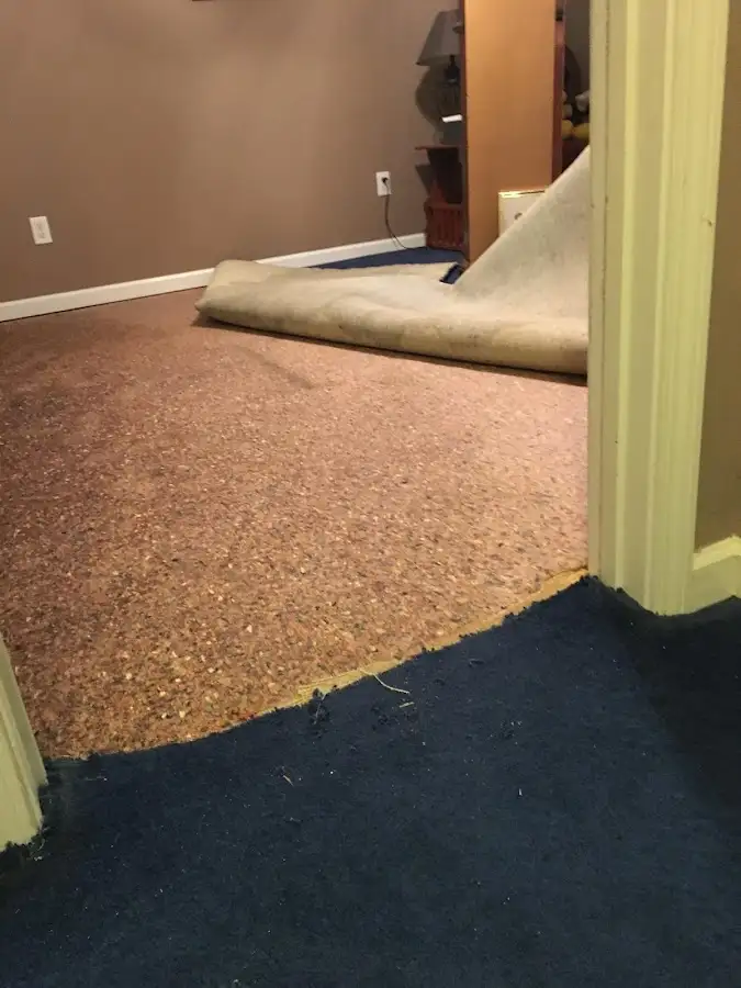 Carpet pad removal revealing water damage during Drying & Dehumidification in Ames